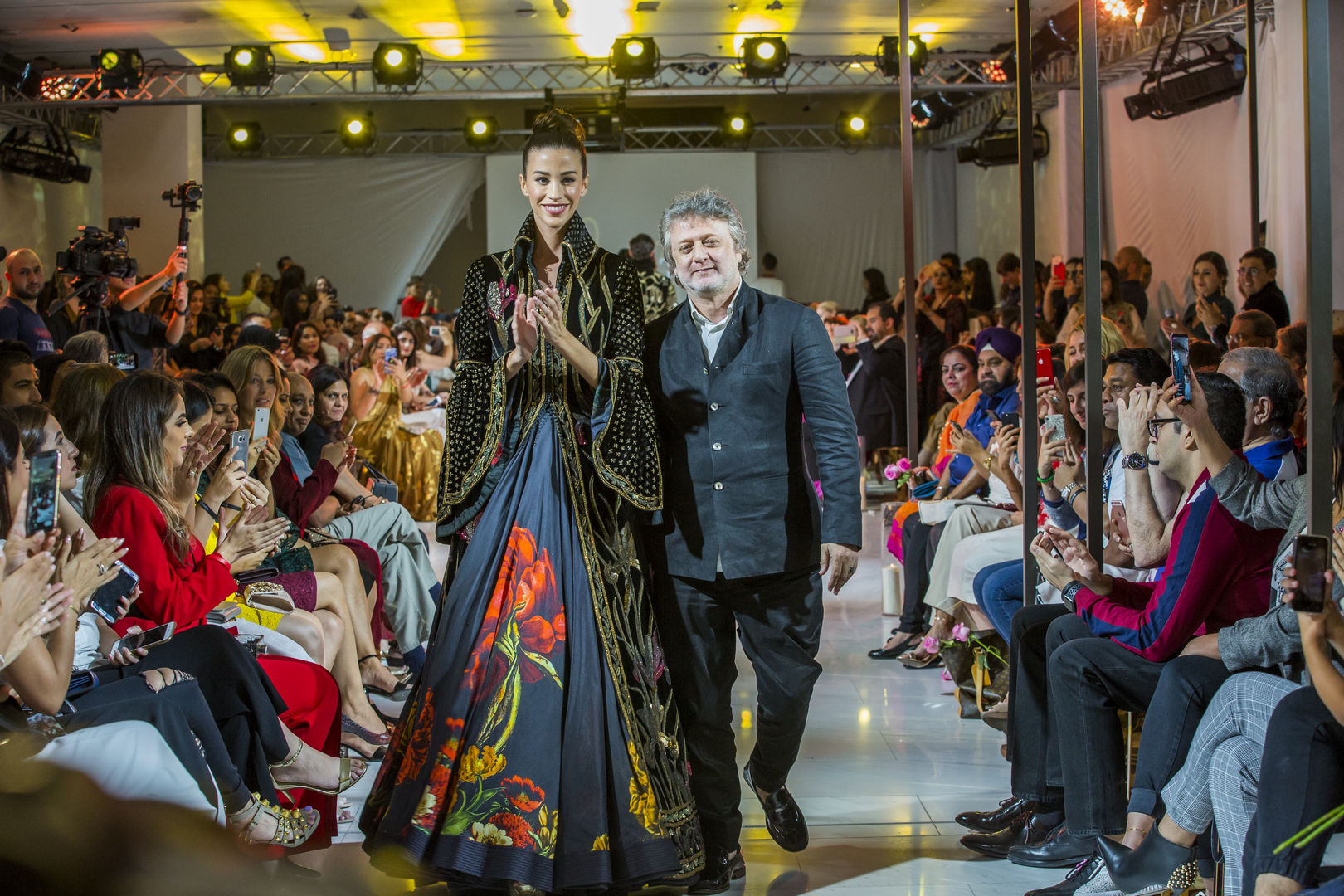 Designer Rohit Bal walks the ramp with the showstopper after showcasing his collection